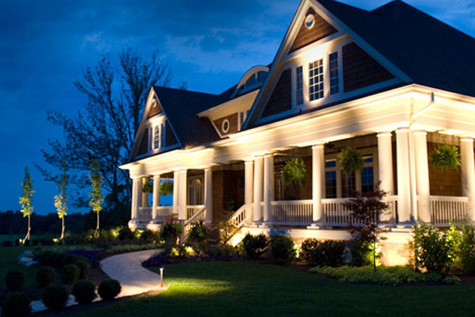 nice home with outdoor lighting at night
